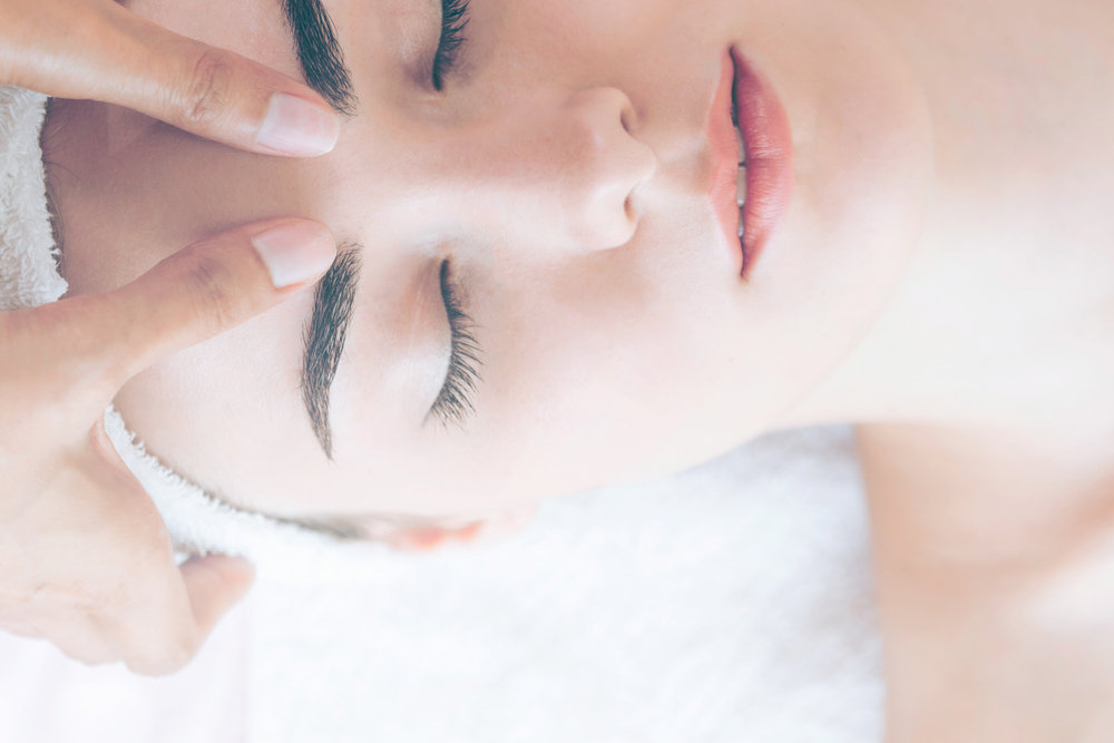 Woman getting massaged during a facial