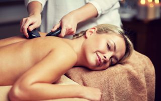 Woman enjoying hot stone massage - 3 Benefits of Hot Stone Massage