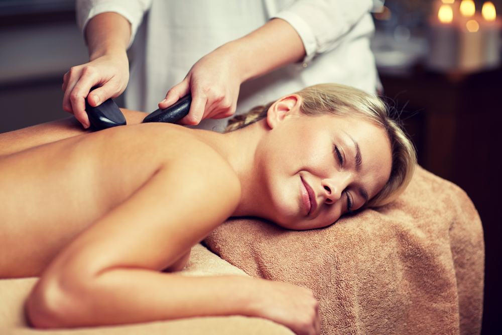 Woman enjoying hot stone massage - 3 Benefits of Hot Stone Massage